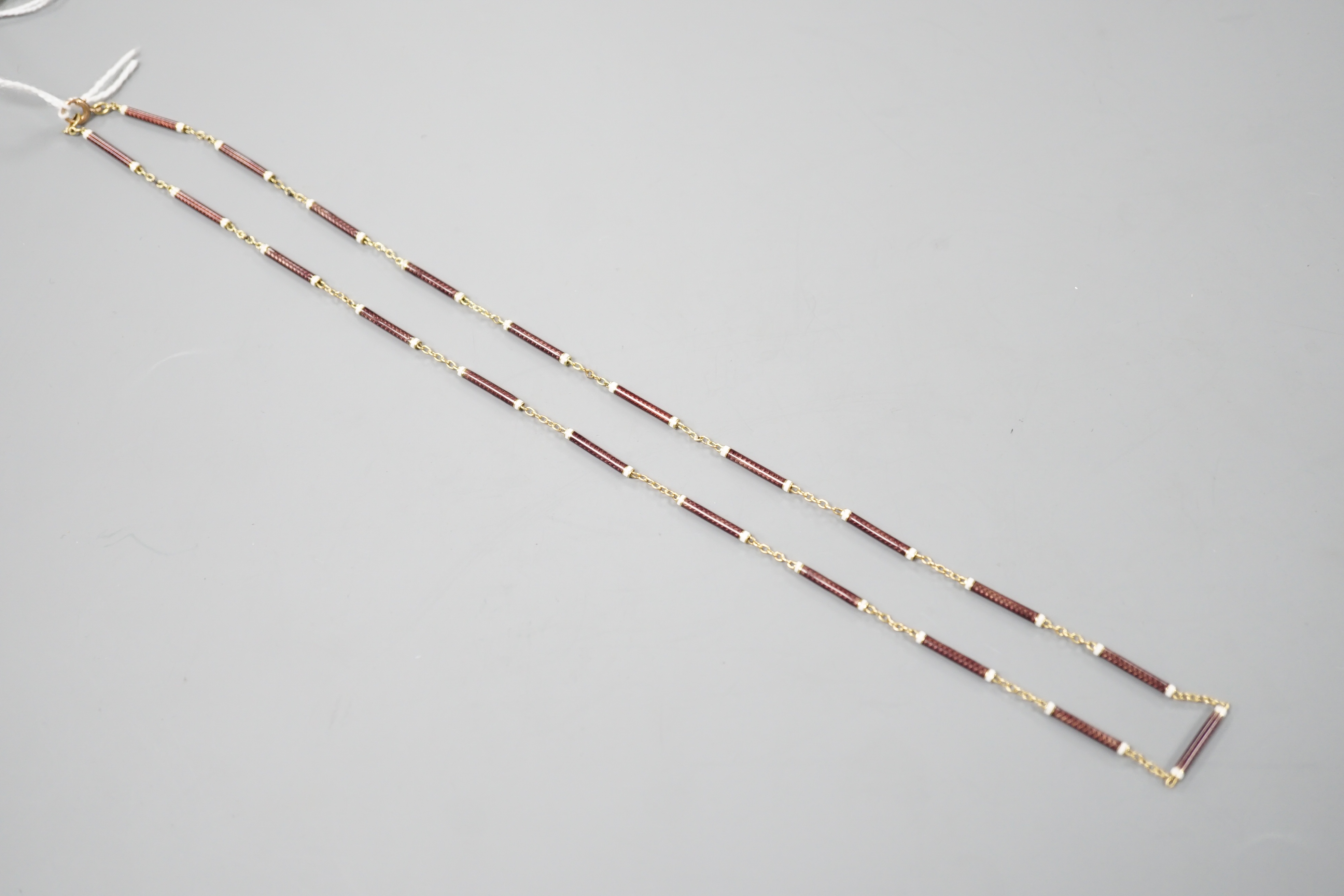 A 9ct and two colour enamelled baton link necklace, 52cm, gross 7.1 grams.